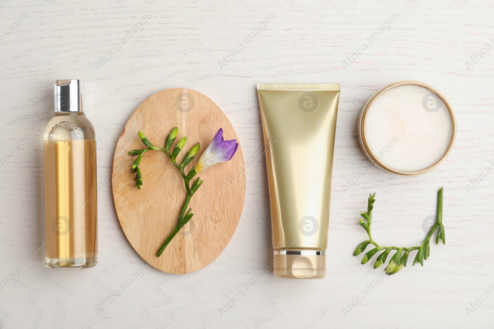 Photo of Flat lay composition with cosmetic products on white wooden table
