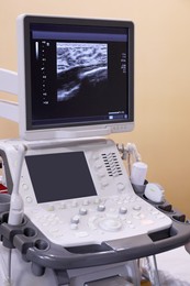 Ultrasound machine with sonogram of woman's breast on screen in hospital