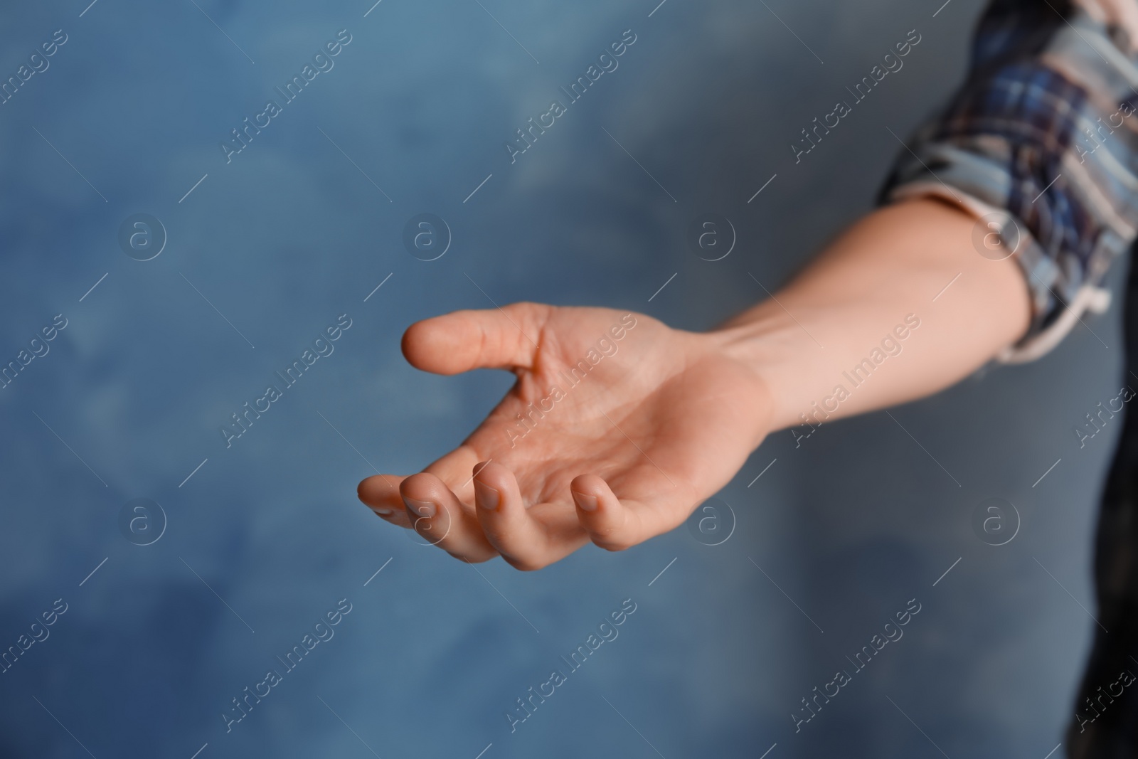 Photo of Woman offering helping hand on color background, closeup