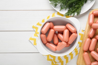 Delicious sausages and dill on white wooden table, flat lay. Space for text