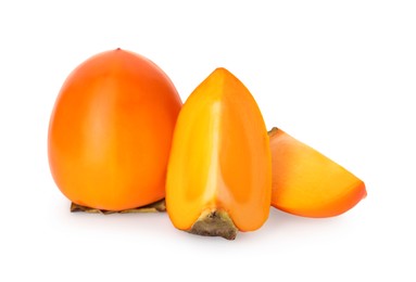 Whole and cut delicious ripe juicy persimmons on white background