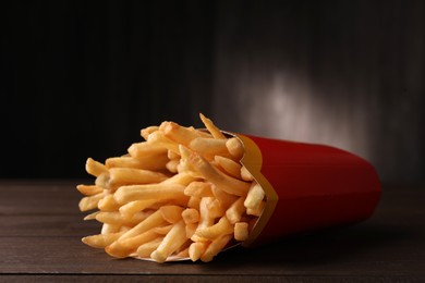 MYKOLAIV, UKRAINE - AUGUST 12, 2021: Big portion of McDonald's French fries on wooden table, closeup