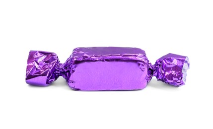 Photo of Tasty candy in purple wrapper isolated on white