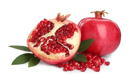 Photo of Ripe pomegranates with green leaves on white background