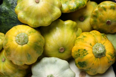 Fresh ripe pattypan squashes as background, top view