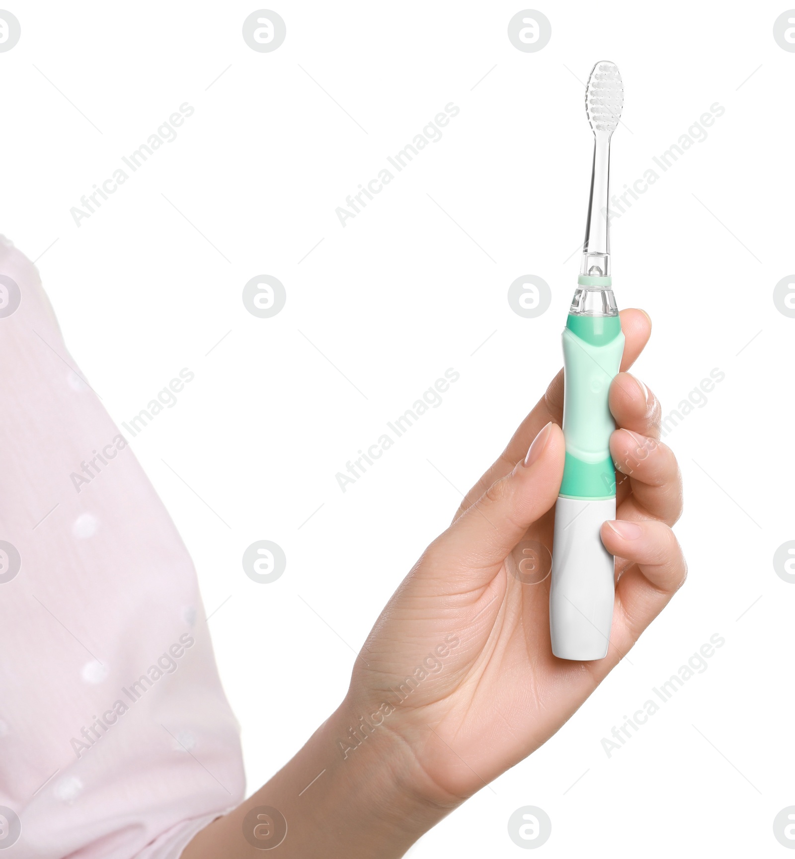 Photo of Woman holding electric toothbrush on white background, closeup