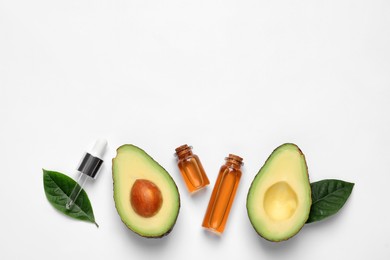 Flat lay composition with essential oil and avocado on white background. Space for text