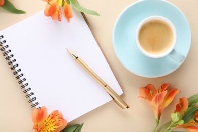 Guest list. Notebook, pen, coffee and beautiful flowers on beige table, flat lay. Space for text