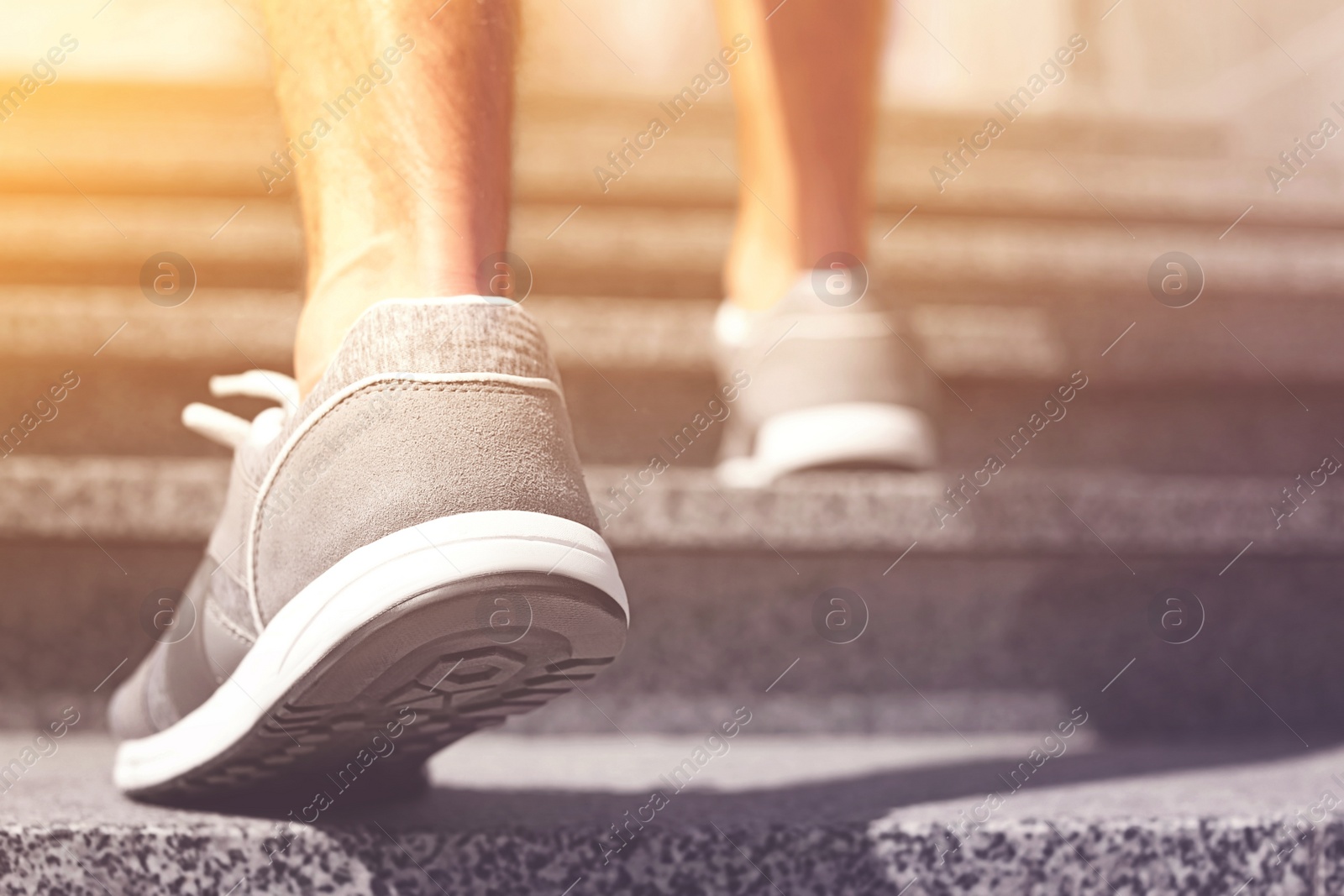 Image of Sporty young man in training shoes outdoors on sunny day, closeup