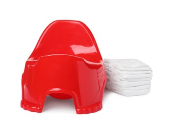 Red baby potty and diapers on white background. Toilet training