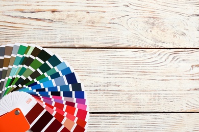 Photo of Color palette samples on wooden background