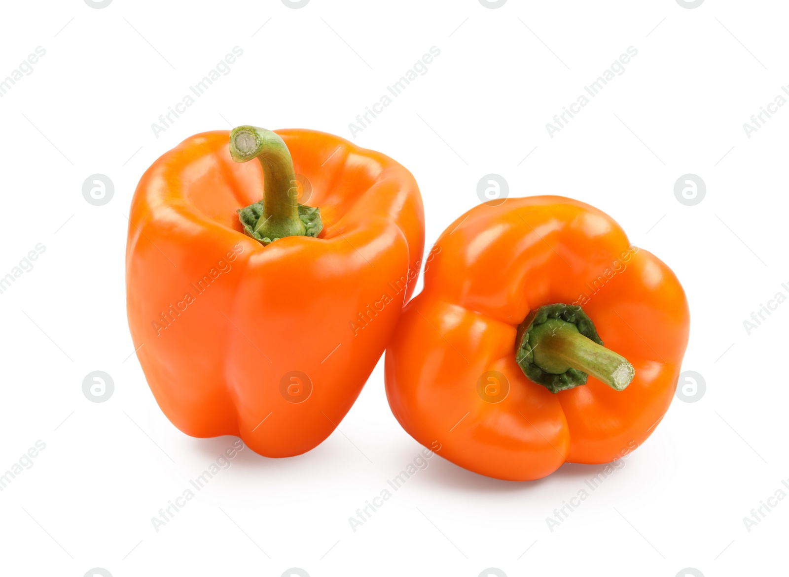 Photo of Ripe orange bell peppers isolated on white