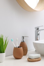 Photo of Set of different bath accessories and products on white table