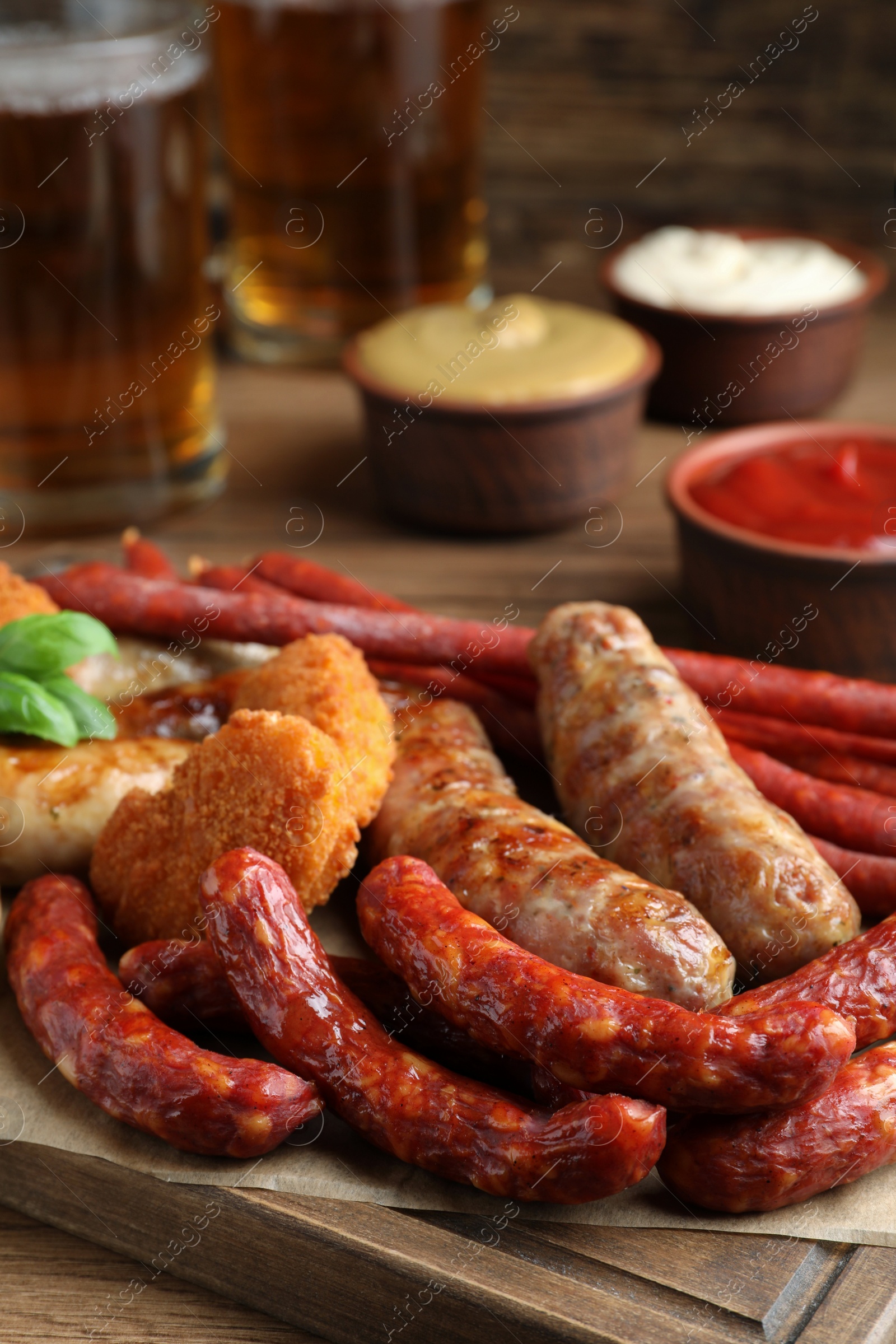 Photo of Set of different tasty snacks on wooden table, closeup view