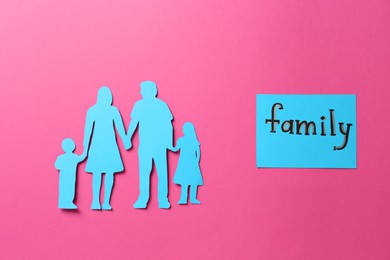 Card with text Family and paper cutout on pink background, flat lay