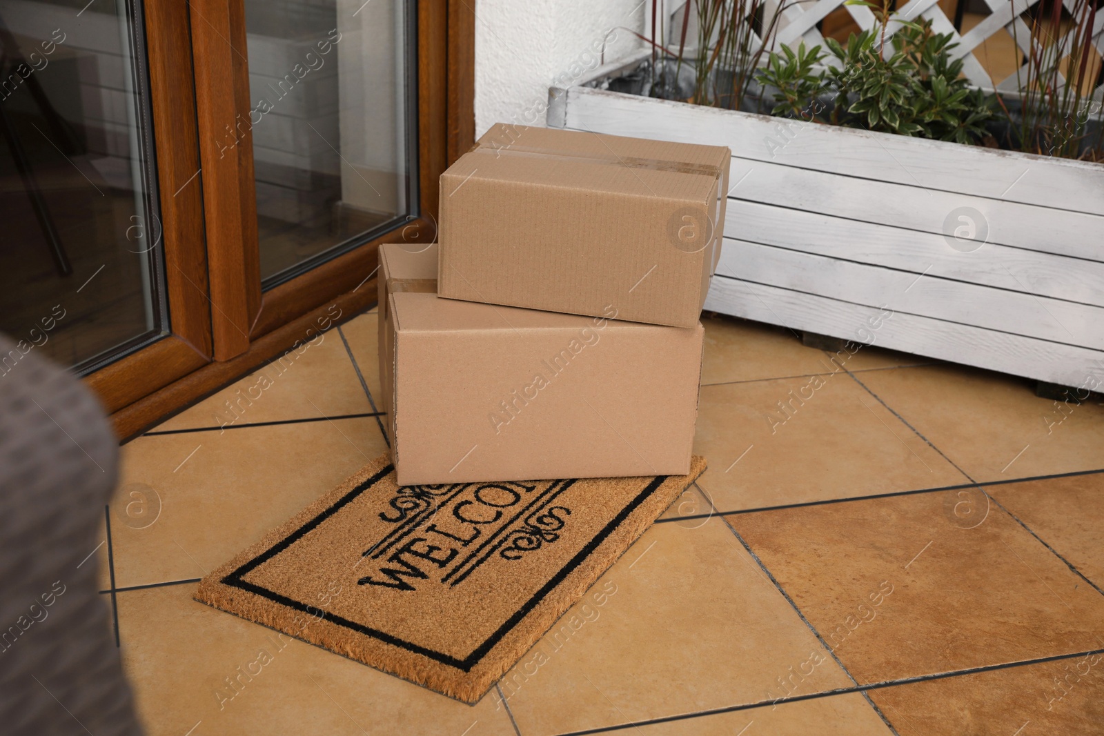 Photo of Parcels delivered on mat near front door