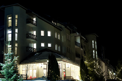 Photo of Beautiful modern hotel at night. Winter vacation