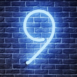 Image of Glowing neon number 9 sign on brick wall