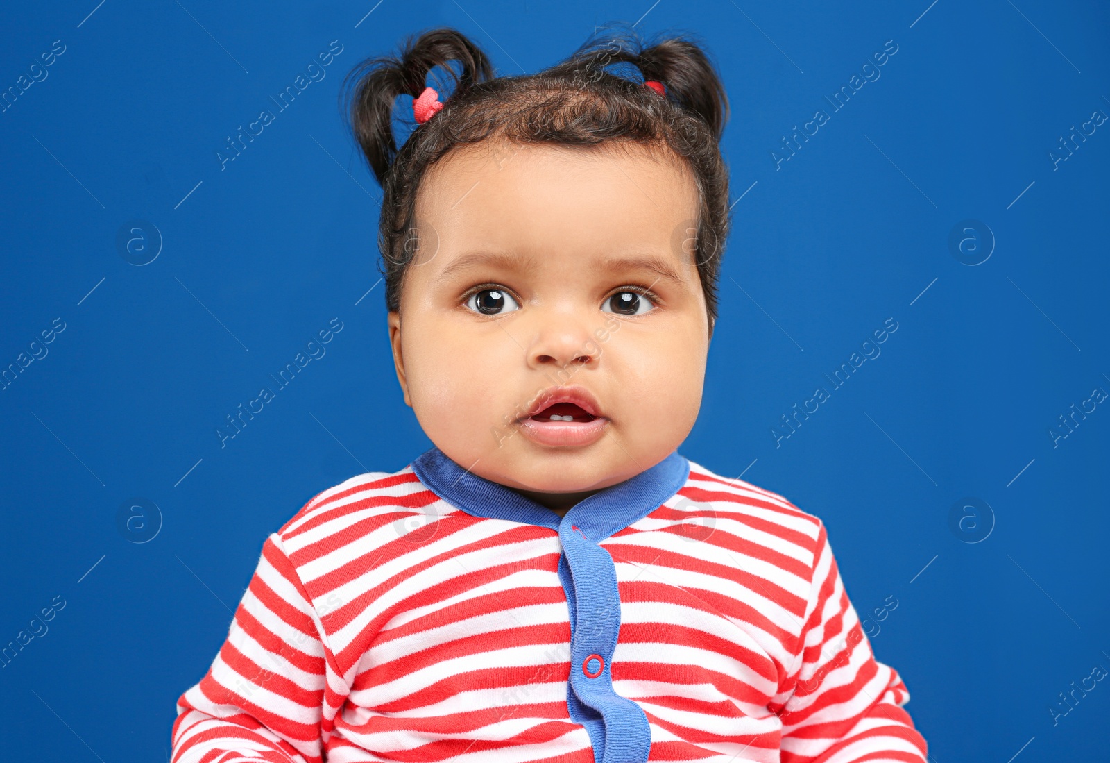 Photo of Cute African American baby on blue background