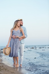 Photo of Young couple spending time together on beach