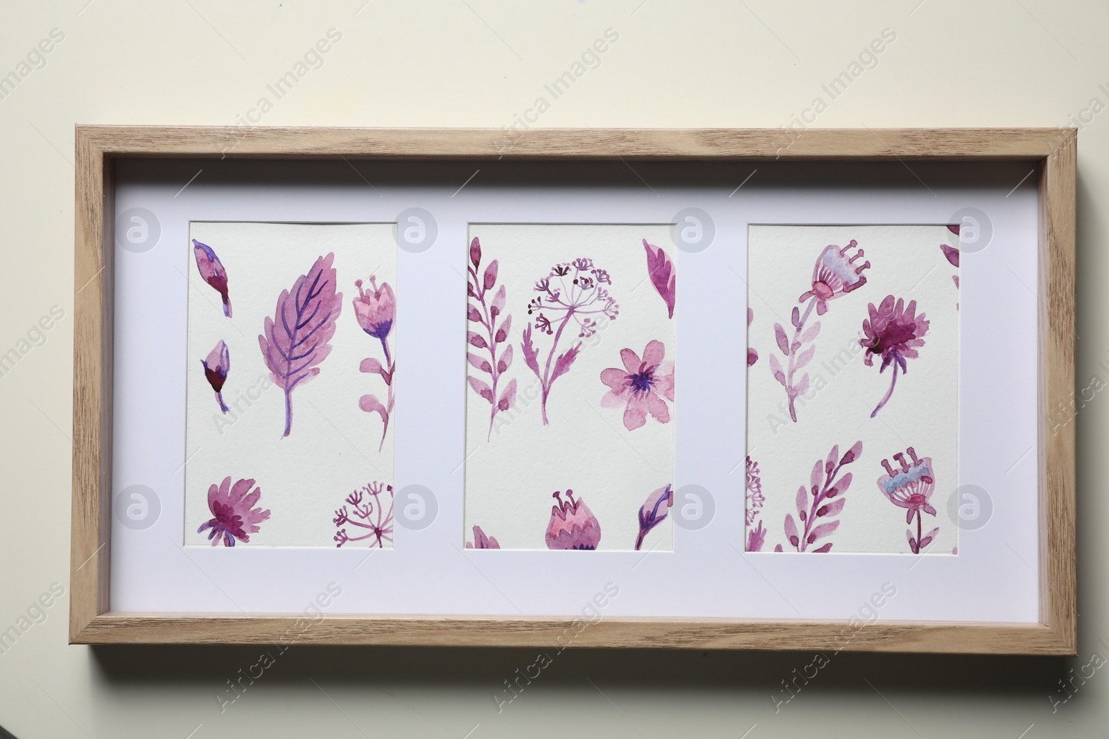 Photo of Frame with floral watercolor paintings on light background