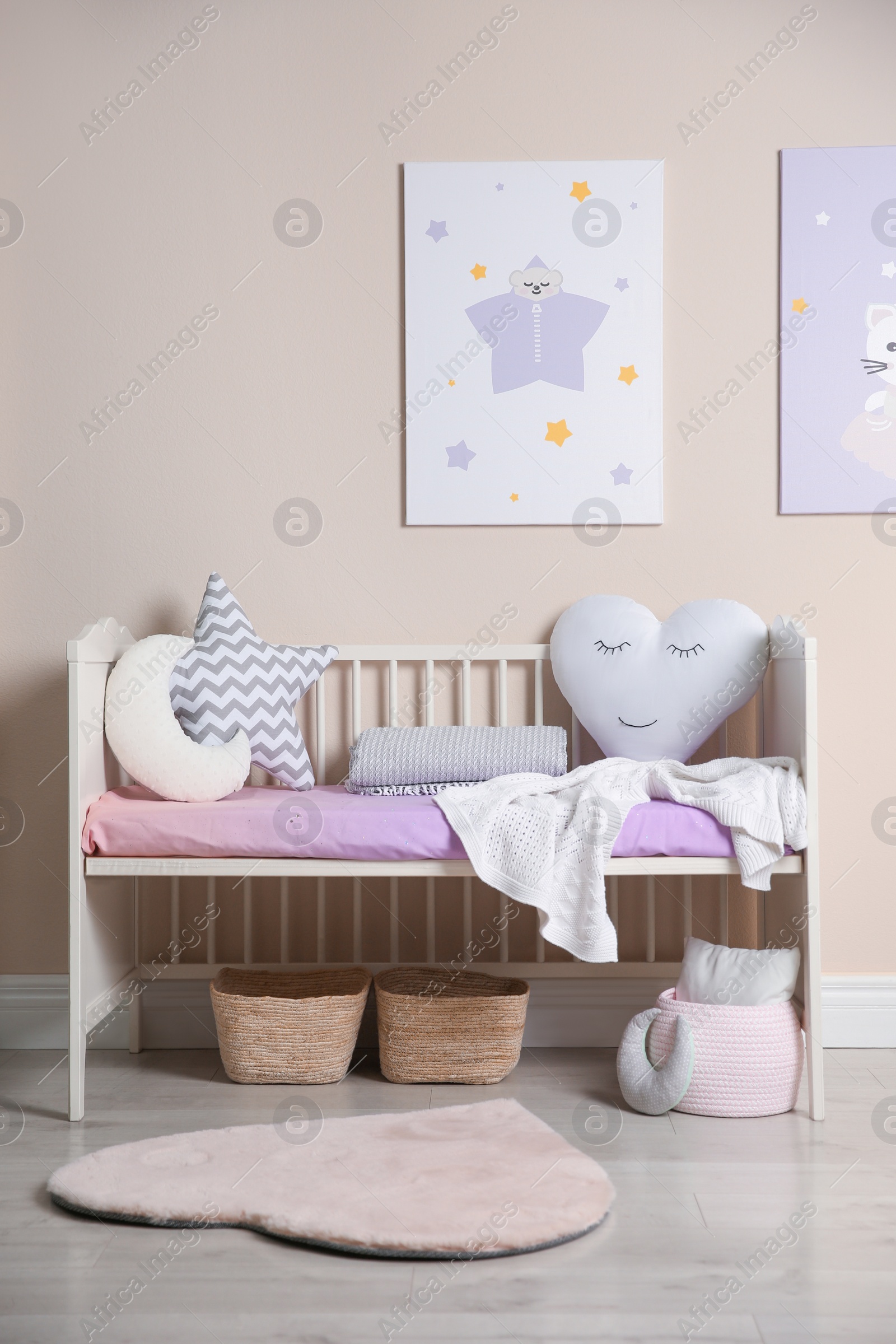 Photo of Cute baby room interior with modern crib and toys