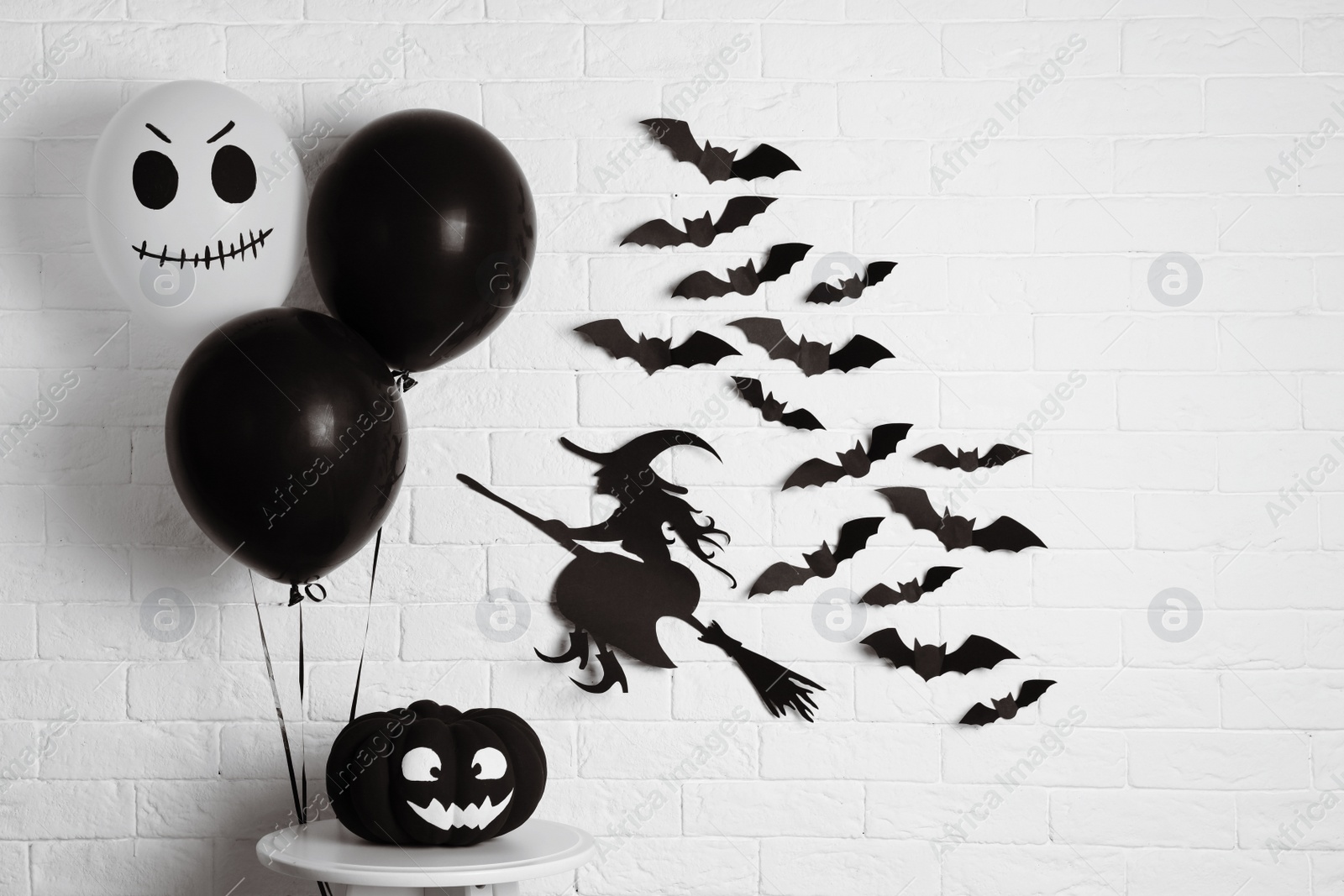 Photo of Set of Halloween decorations near brick wall