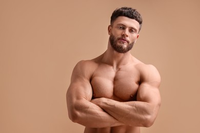 Photo of Handsome muscular man on beige background. Sexy body
