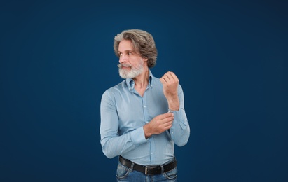 Portrait of handsome mature man on blue background