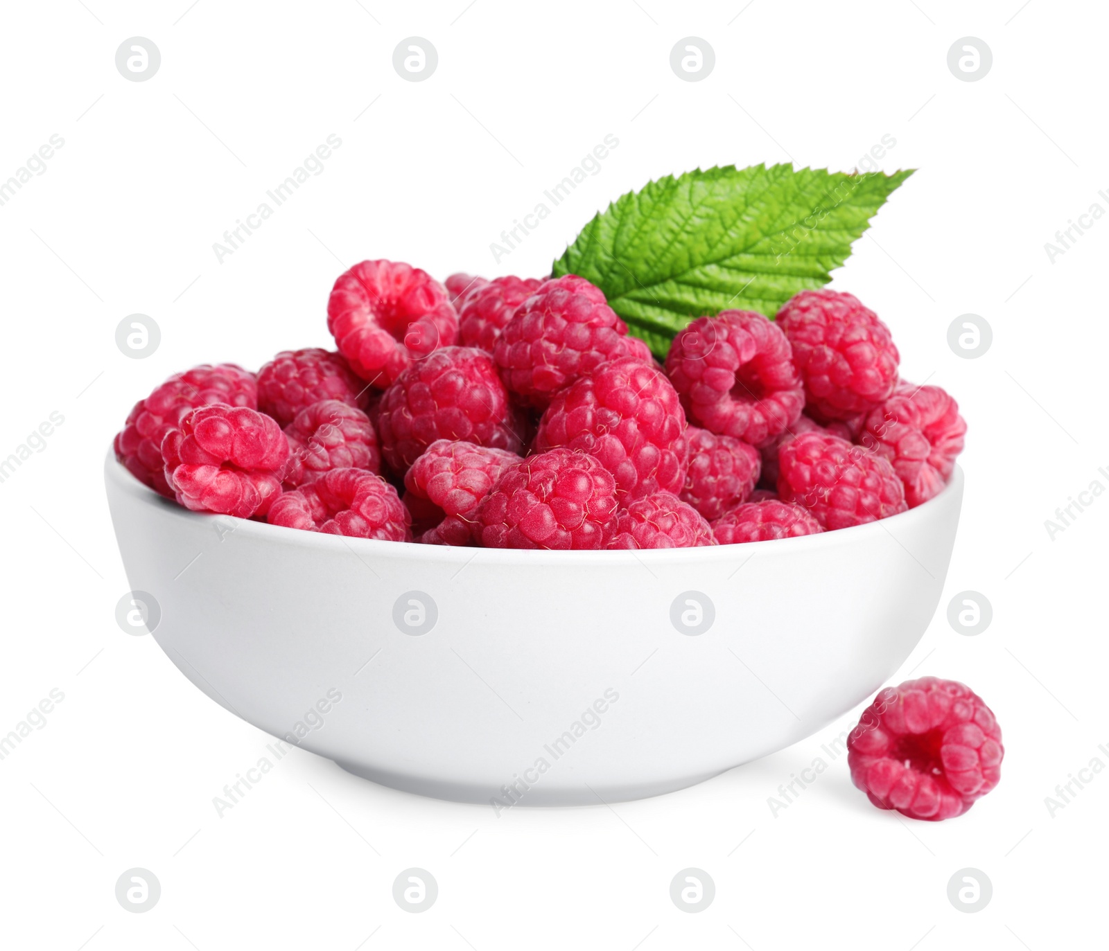 Photo of Bowl of fresh ripe raspberries with green leaf isolated on white