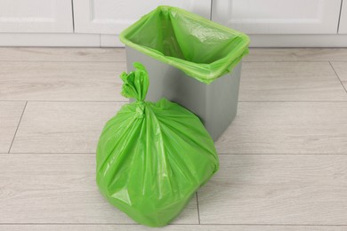 Photo of Plastic garbage bag and trash can indoors