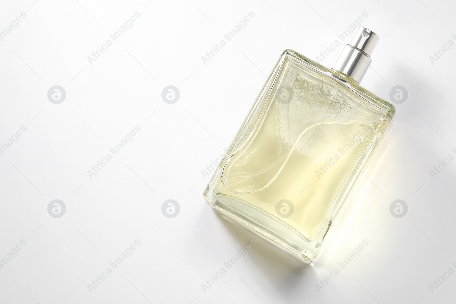 Photo of Luxury men`s perfume in bottle on white background, top view. Space for text