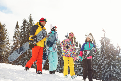 Group of friends with equipment on snowy slope. Winter vacation
