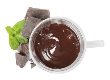 Photo of Glass cup of delicious hot chocolate, chunks and fresh mint on white background, top view