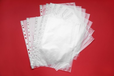 Photo of Punched pockets on red background, flat lay