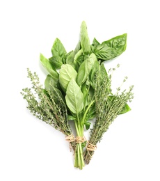 Fresh green basil and thyme on white background, top view. Aromatic herbs