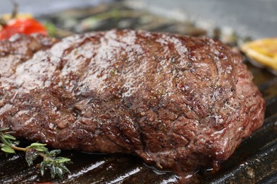 Photo of Delicious grilled beef meat in pan, closeup