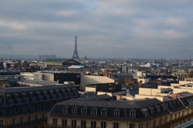 Paris, France - December 10, 2022: Panoramic view of city with Eiffel Tower on cloudy day