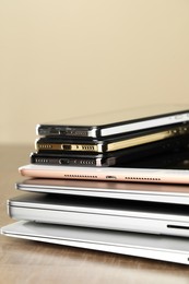 Photo of Stack of electronic devices on wooden table