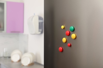 Photo of Many colorful magnets on refrigerator door indoors