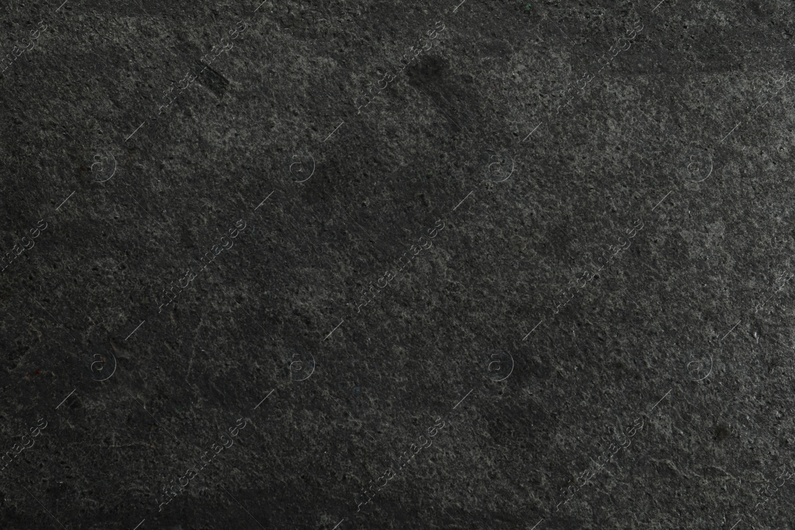 Photo of Texture of dark grey stone surface as background, closeup