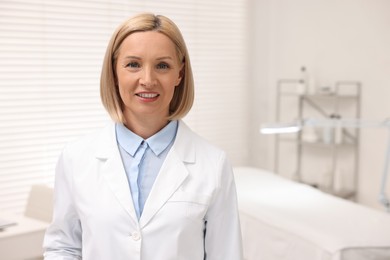 Photo of Portrait of happy dermatologist in modern clinic, space for text