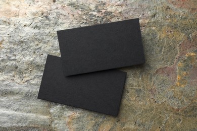 Photo of Blank business cards on stone background, top view. Mockup for design