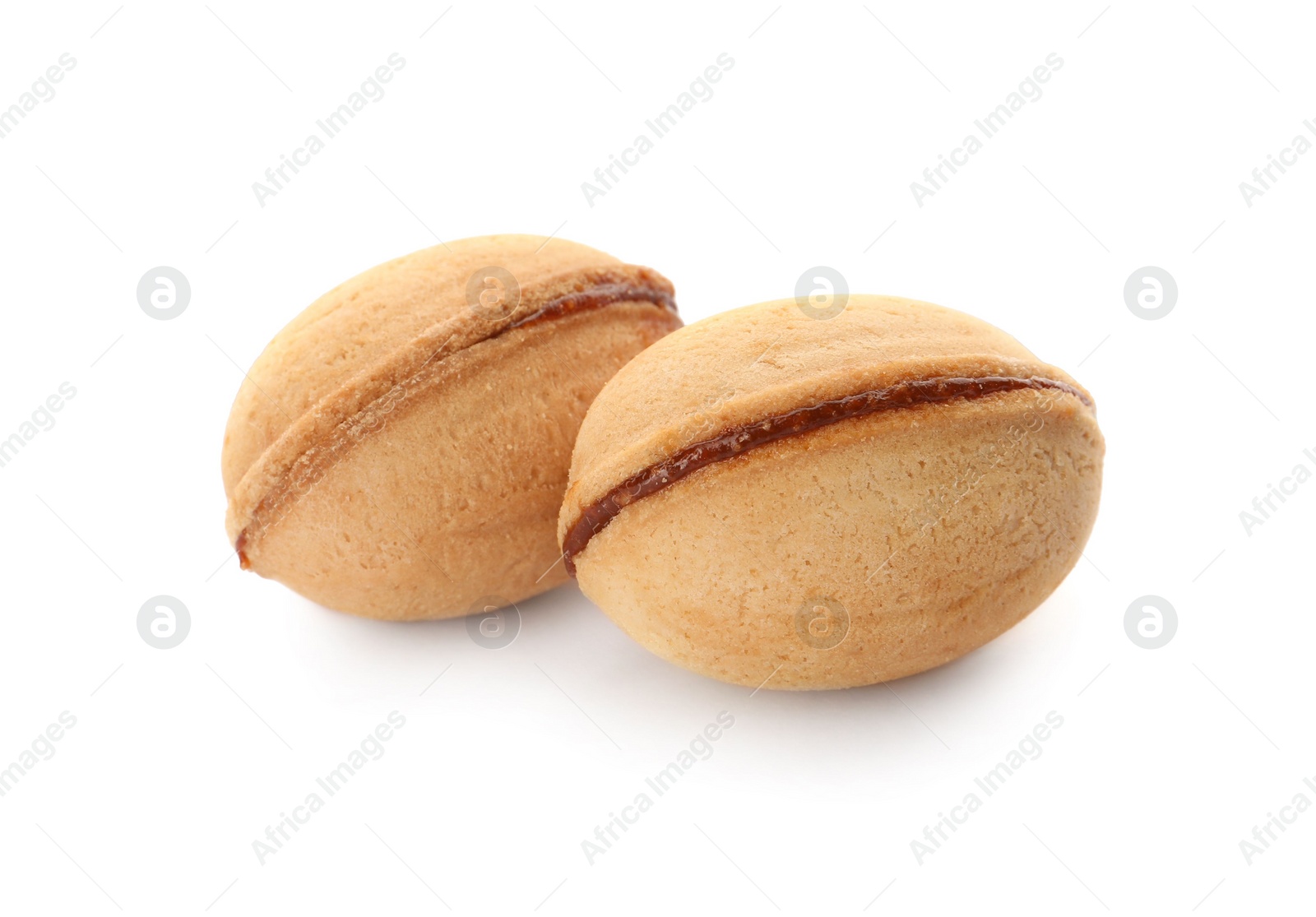 Photo of Delicious nut shaped cookies with boiled condensed milk on white background