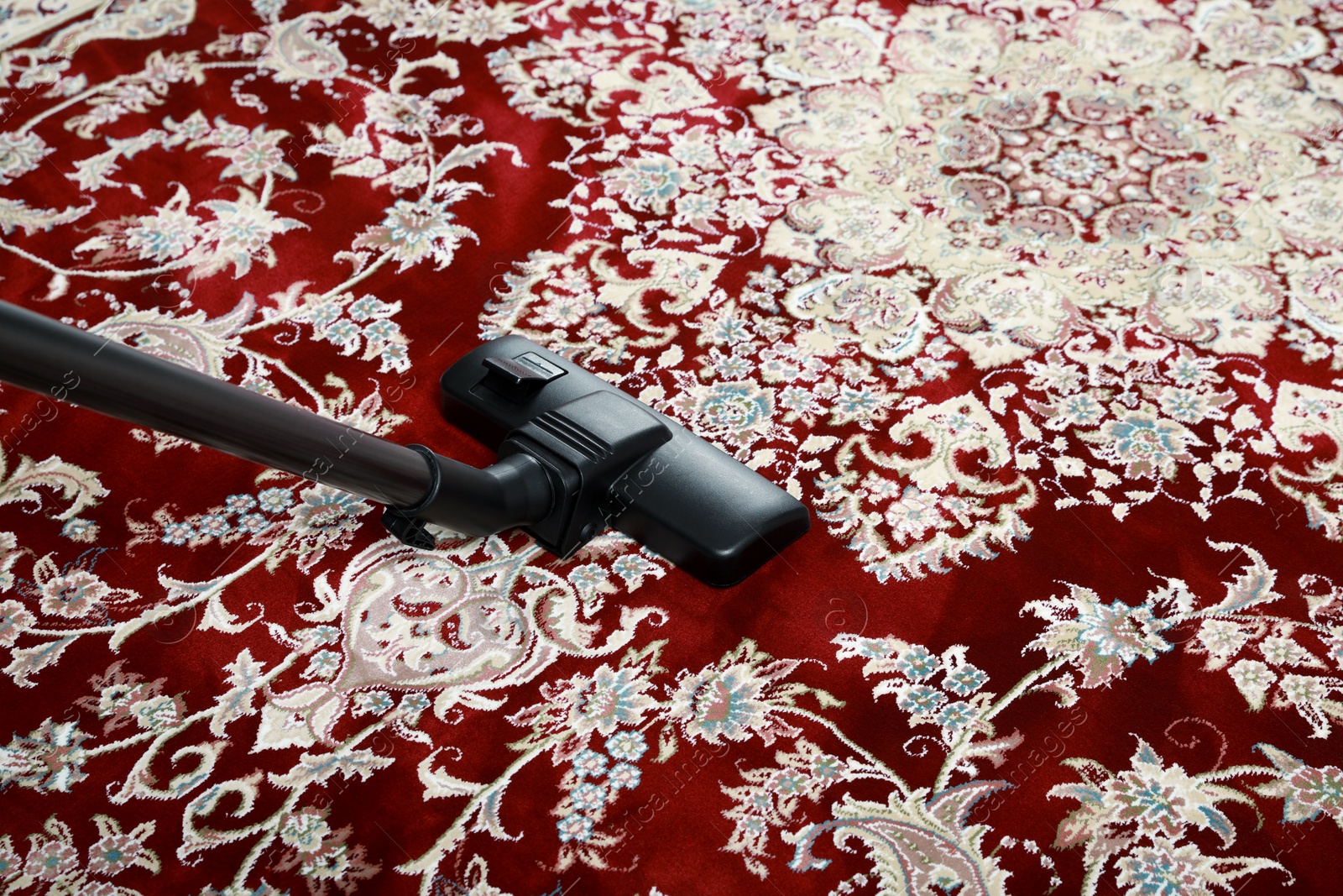 Photo of Removing dirt from carpet with modern vacuum cleaner. Space for text