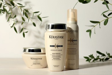 MYKOLAIV, UKRAINE - SEPTEMBER 07, 2021: Set of Kerastase hair care cosmetic products on white wooden table