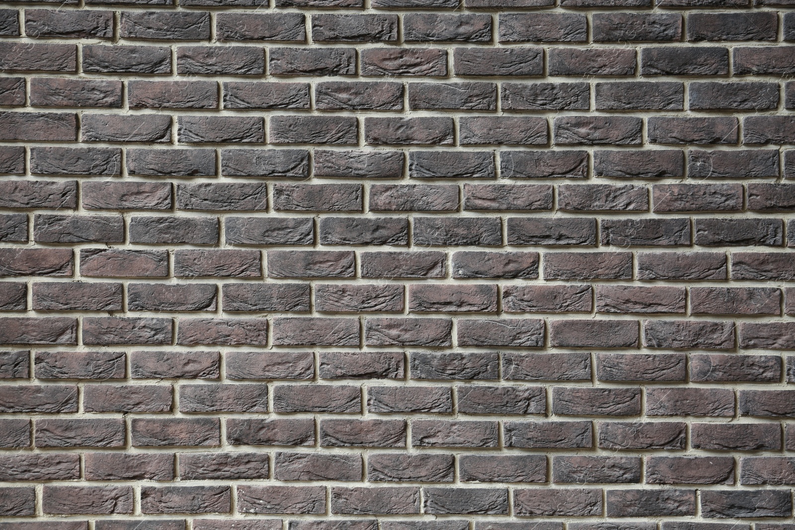 Photo of Texture of brown brick wall as background, closeup