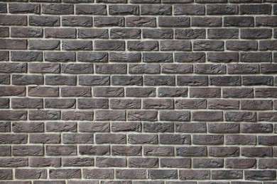 Texture of brown brick wall as background, closeup