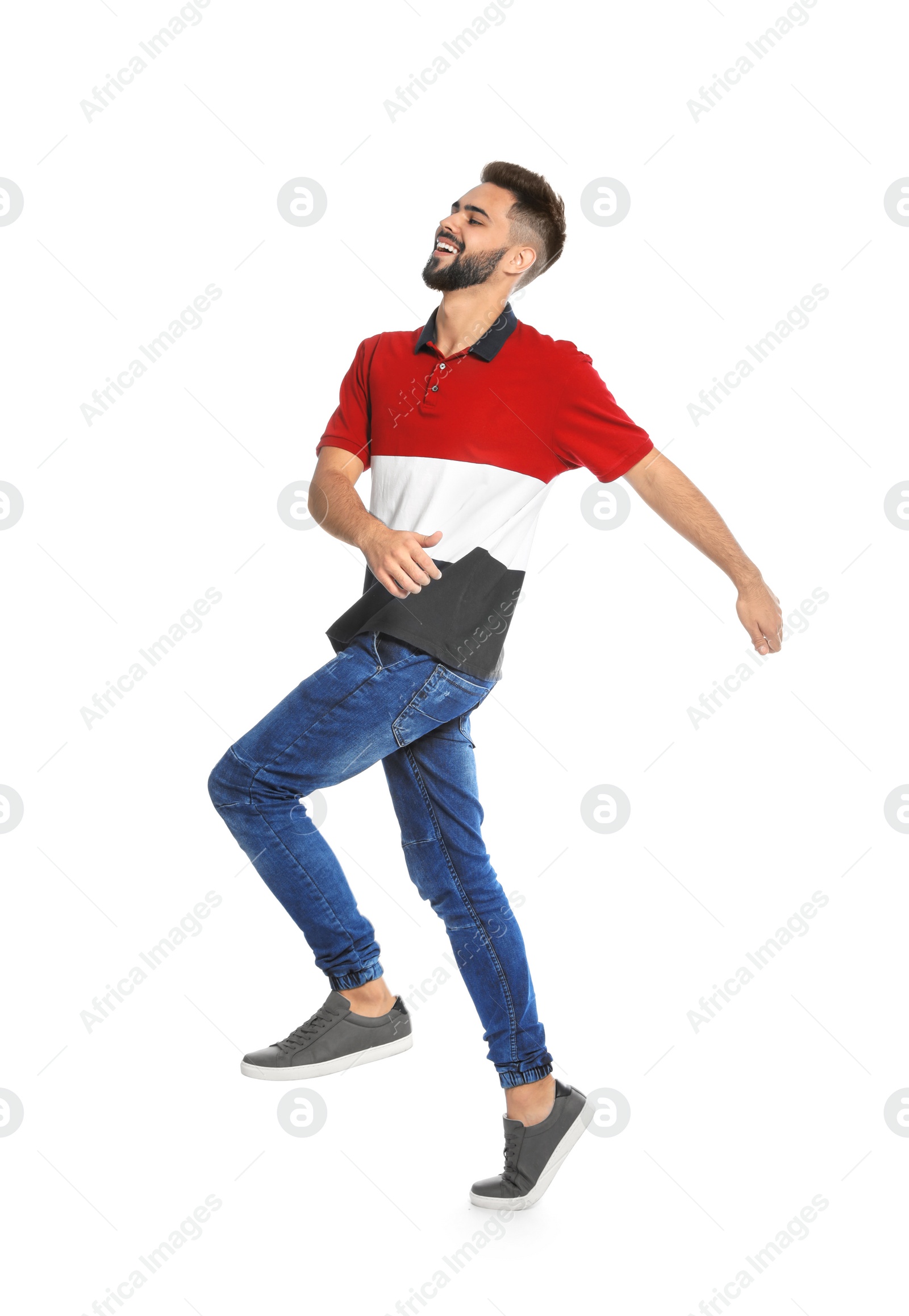 Photo of Handsome young man jumping on white background