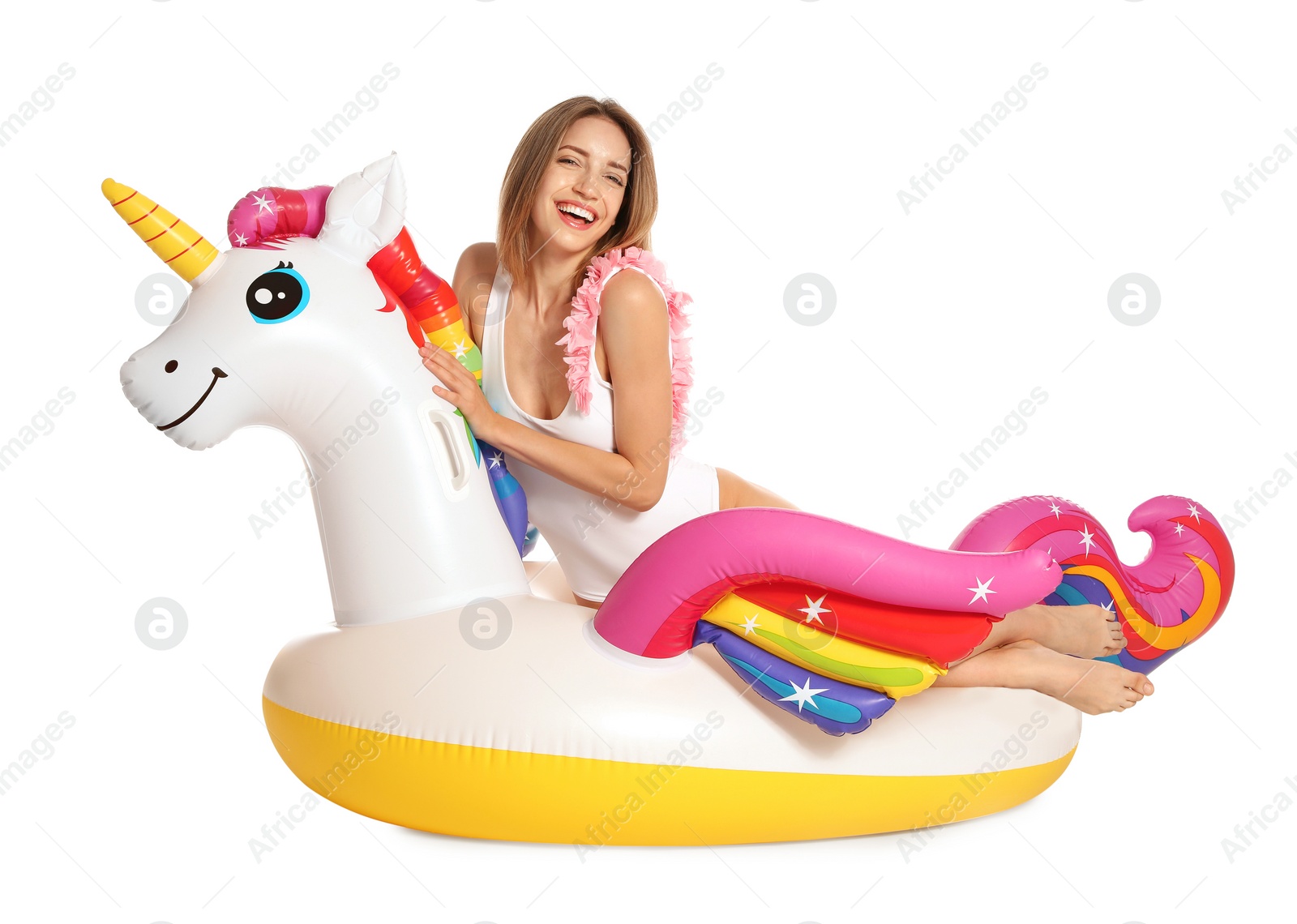 Photo of Beautiful young woman in stylish bikini with  unicorn inflatable ring on white background